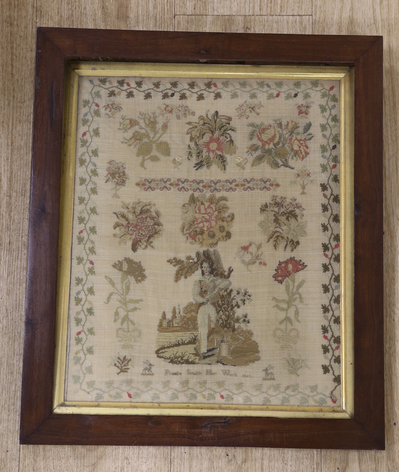 A 19th century sampler by Phoebe Smith Her Work 1842, of a boy amongst a churchyard watering plants, 50.5 x 43cm